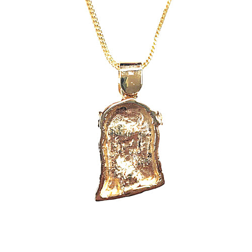 Back of a jesus pendant necklace featuring a textured, irregularly shaped gold charm with a polished top bail, suspended from a fine gold chain against a plain white background.
