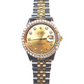 Rolex Datejust watch with a gold dial, diamond hour markers, a diamond-encrusted bezel, and a two-tone stainless steel and gold Oyster bracelet, shown on a white background.