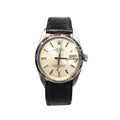 Rolex Oyster Perpetual Date watch with a silver-tone stainless steel case, cream-colored dial, and a black leather strap, shown against a plain white background.