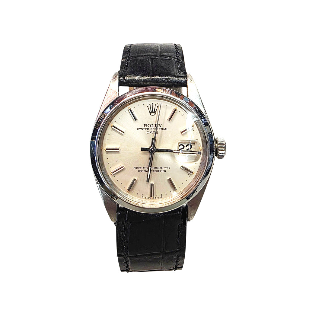 Rolex Oyster Perpetual Date watch with a silver-tone stainless steel case, cream-colored dial, and a black leather strap, shown against a plain white background.