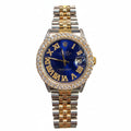 A Rolex Oyster Perpetual Classique watch featuring a blue dial with gold Roman numerals, a diamond-encrusted bezel, and a two-tone yellow and silver stainless steel Oyster bracelet.