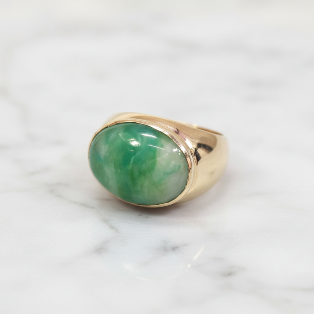 Jade ring with horizontal stone design on marble