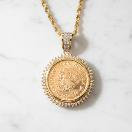 Mexican gold coin pendant on marble