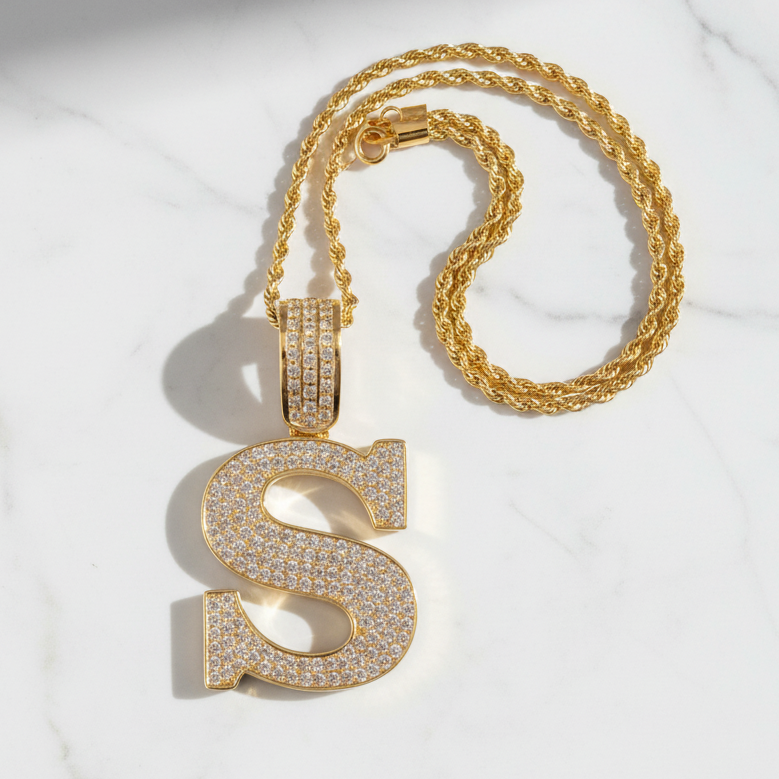 S pendant on white marble