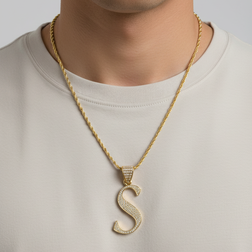 S pendant worn on a man's neck